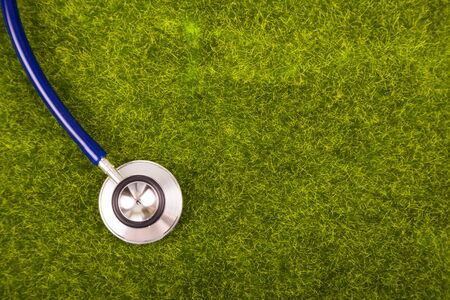Stethoscope on green grass close-up. Nature and medicine.の写真素材