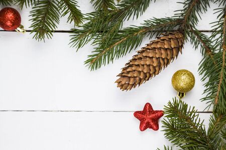 Spruce branch and balls. Christmas still life on a wooden table.Border.