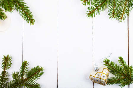 Christmas balls in the shape of hearts and spruce branches on a wooden background. Beautiful still...