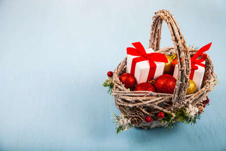 Basket with Christmas presents on a blue background. Congratulations on New Year or Christmas.の写真素材