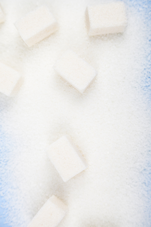 White sugar and cubes of sugar on an old wooden backgroundの写真素材