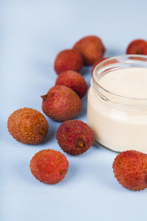 Yoghurt with lychee on a wooden background. Tasty breakfast. Healthy eating.の写真素材
