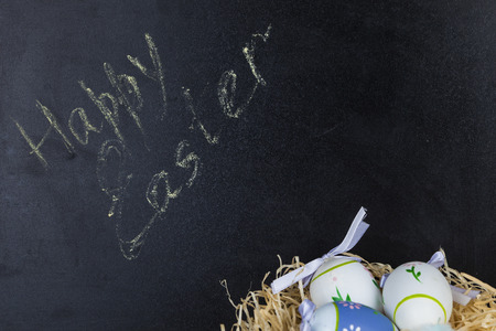 Easter eggs in nest on a chalkboard background. Easter still life.Happy Easter.の写真素材