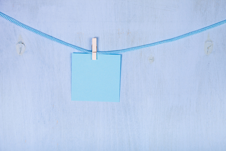 Paper hang on a rope on a blue wooden background.の写真素材