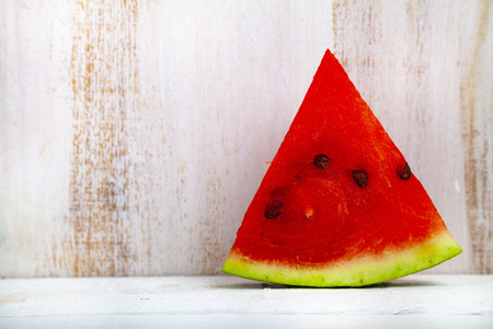 Piece of watermelon on a wooden table. Delicious dessert.の写真素材