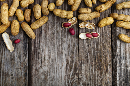 Peanuts on a wooden background. Delicious and healthy nuts close-up.  Place for your text.