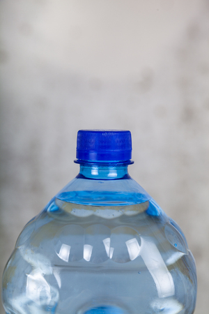 Bottle of water on a gray background. Clear drinking waterの写真素材