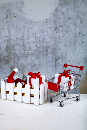 Christmas gifts and decorations in a white box on a grunge background. Christmas sale.の写真素材