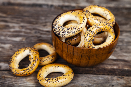 Bagels in a wooden bowl on the old wooden background.の写真素材