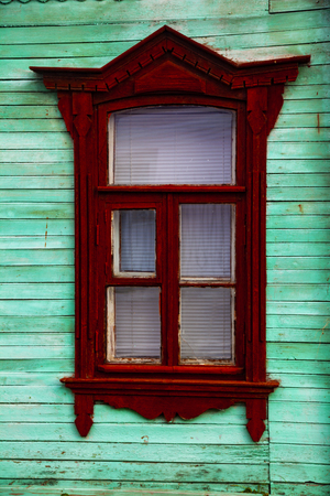 Window in an old wooden house close-up. Architectural detail.の写真素材