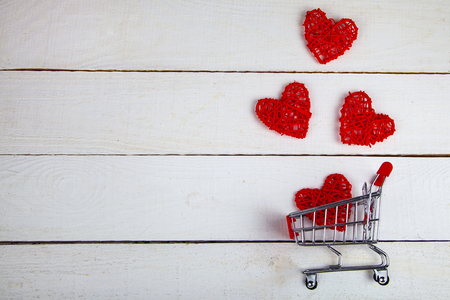 Hearts in the shopping cart on a white background. Shopping for the holiday.の写真素材