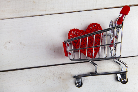 Heart in the shopping cart on a white background. Shopping for the holiday.の写真素材