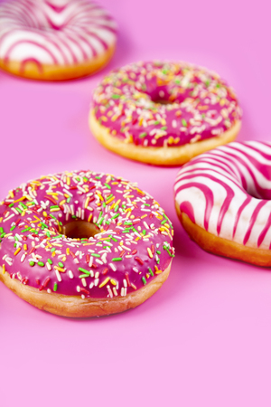 Donuts on a pink background. Delicious dessert.の写真素材