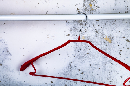 Red hanger on a gray wall background.の写真素材