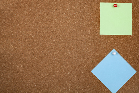 Two sheets of paper on corkboard. Place for your text.の写真素材
