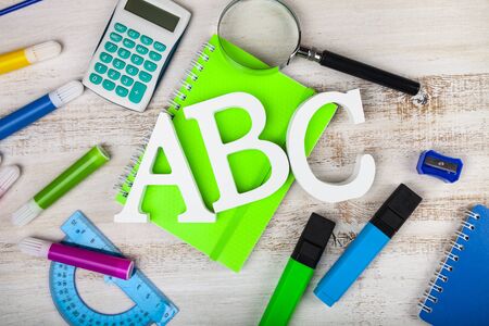 Back to school. Items for the school and letters ABC on a wooden table.の写真素材