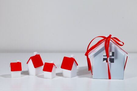 Small houses with red covers.Concept: buying, selling and renting real estate.の写真素材