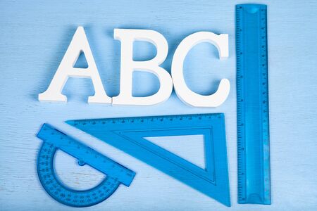 Back to school. Rulers for the school and letters ABC on a wooden tableの写真素材