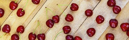 Ripe sweet cherries on a wooden background. Tasty berries. Still life.の写真素材