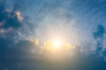Beautiful blue sky and a ray of sun from behind the clouds.の写真素材
