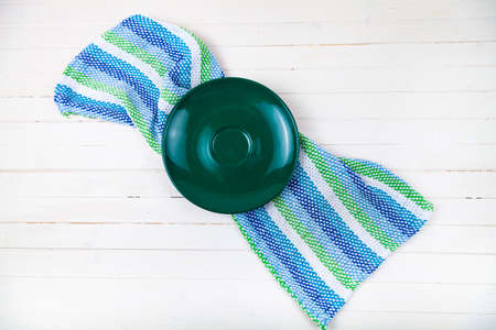 Empty green plate and towel on a wooden background.の写真素材