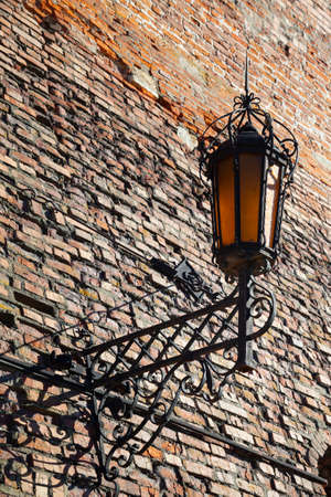 Lantern on an old brick wall. Fragment of the Kolomna Kremlin. Kolomna, Russia.の写真素材