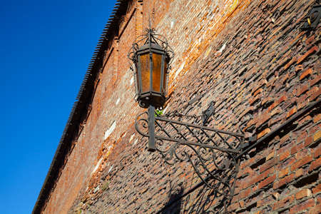 Lantern on an old brick wall. Fragment of the Kolomna Kremlin. Kolomna, Russia.の写真素材