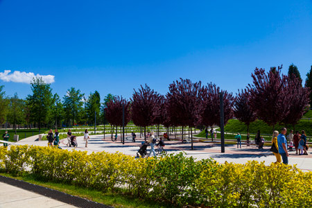 City Park "Krasnodar" or Galitsky Park. People walk in a picturesque park around the football stadium "Krasnodar". Landscaping. Krasnodar, Russia - May 5, 2021のeditorial素材