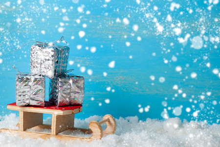 Sleds and New Year's gifts in the snow. Place for your text. Christmas decor.の写真素材