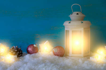 Christmas decor with lantern and decorations in the snow. Greeting card.の写真素材