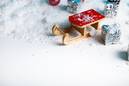 Sleds and New Year's gifts in the snow. Place for your text. Christmas decor.の写真素材
