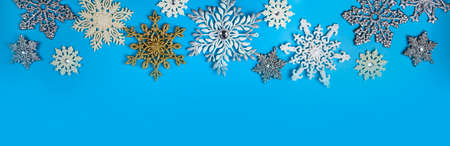 Border from snowflakes on a blue background. Christmas decor. Place for your text.の写真素材