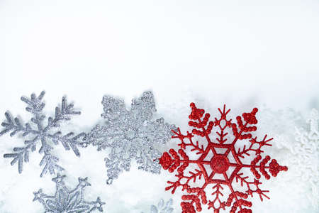 Border of snowflakes in the snow on a white background.Christmas decor. Place for your text.の写真素材