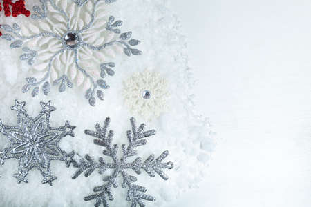 Border of snowflakes in the snow on a white background.Christmas decor. Place for your text.の写真素材
