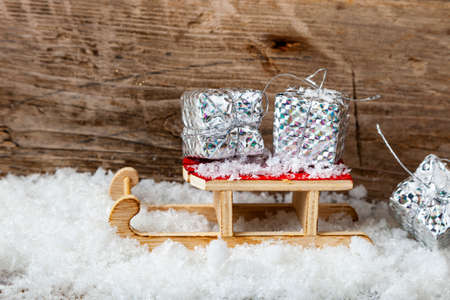 Silver boxes with gifts for a sled in the snow. Christmas gifts.の写真素材