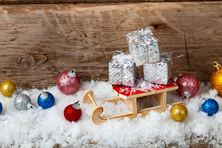 Silver boxes with gifts for a sled in the snow. Christmas gifts.の写真素材