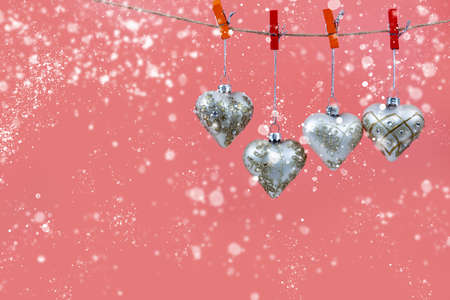 Christmas balls hearts on a pink background. Beautiful Christmas card.の写真素材