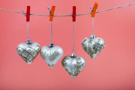 Christmas balls hearts on a pink background. Beautiful Christmas card.の写真素材