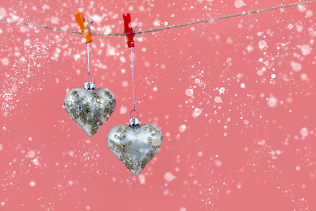 Christmas balls hearts on a pink background. Beautiful Christmas card.の写真素材