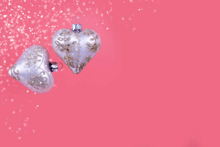 Christmas balls hearts on a pink background. Beautiful Christmas card.の写真素材