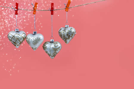 Christmas balls hearts on a pink background. Beautiful Christmas card.の写真素材