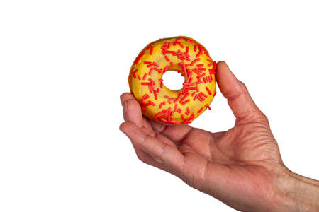 Donut in a man's hand isolated on a white background.