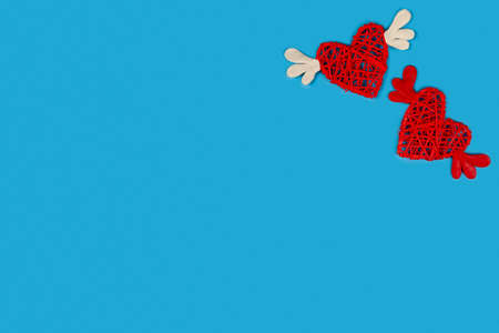 Hearts with wings on a blue background. Place for your text. Festive card for Valentine's Day.
