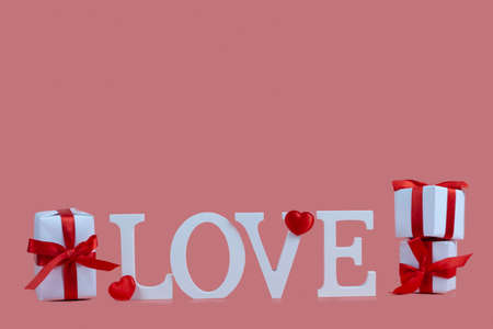 Word Love and hearts on a pink background. Valentine's day card. Place for your text.の写真素材