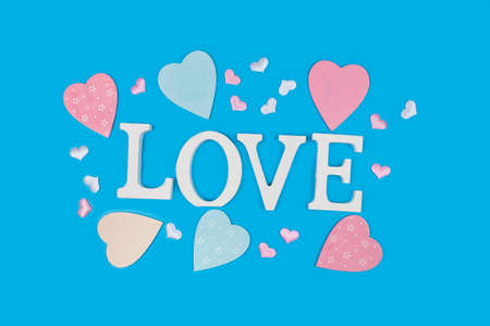 Word Love and hearts on a blue background. Valentine's day card. Place for your text.