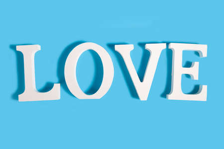 Word Love and heart on a blue background. Valentine's day card.の写真素材