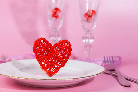 Valentine's day romantic dinner with red hearts on pink background. copyspace.の写真素材