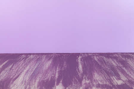 Old damaged cracked paint wall, grunge background, purple pastel color.の写真素材