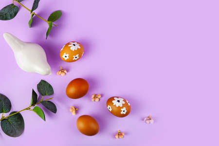 Easter card design. Easter eggs decorated with flowers on lilac background. Flat lay, top view, copy space.の写真素材