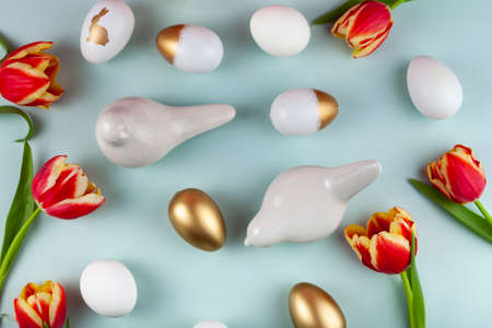 Tulip flowers, birds and easter eggs on green background. Top view with copy space. happy easter greeting cardの写真素材